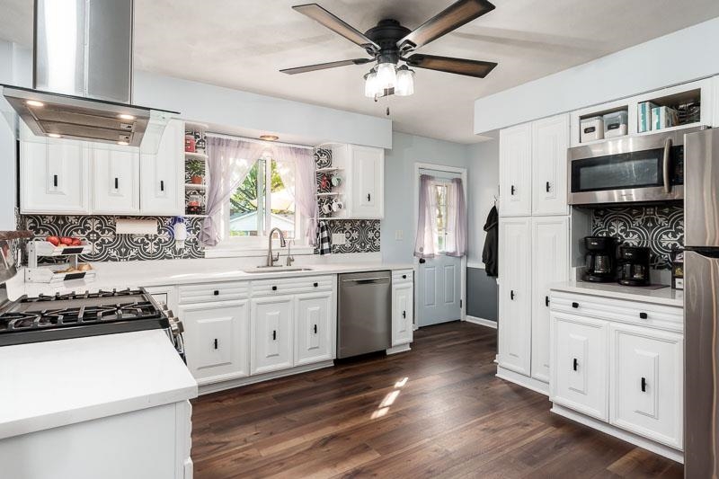 4853 Braewild Road Rockford, IL 61107 - Photo 12 of 46 a kitchen with white cabinets and appliances