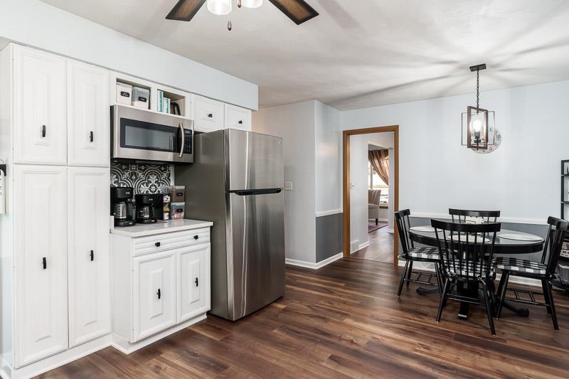 4853 Braewild Road Rockford, IL 61107 - Photo 13 of 46 a kitchen with stainless steel appliances a refrigerator stove microwave and cabinets