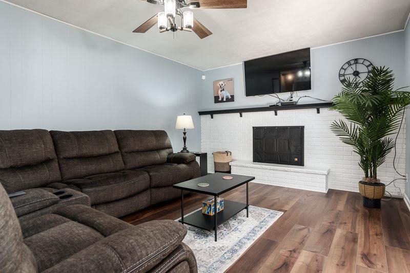 4853 Braewild Road Rockford, IL 61107 - Photo 17 of 46 a living room with furniture a flat screen tv and a fireplace