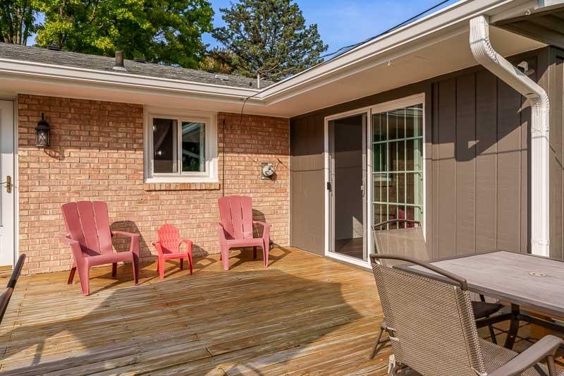 4853 Braewild Road Rockford, IL 61107 - Photo 40 of 46 a backyard of a house with wooden chairs and wooden floor