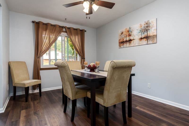 4853 Braewild Road Rockford, IL 61107 - Photo 9 of 46 a dining room with furniture a large window and wooden floor