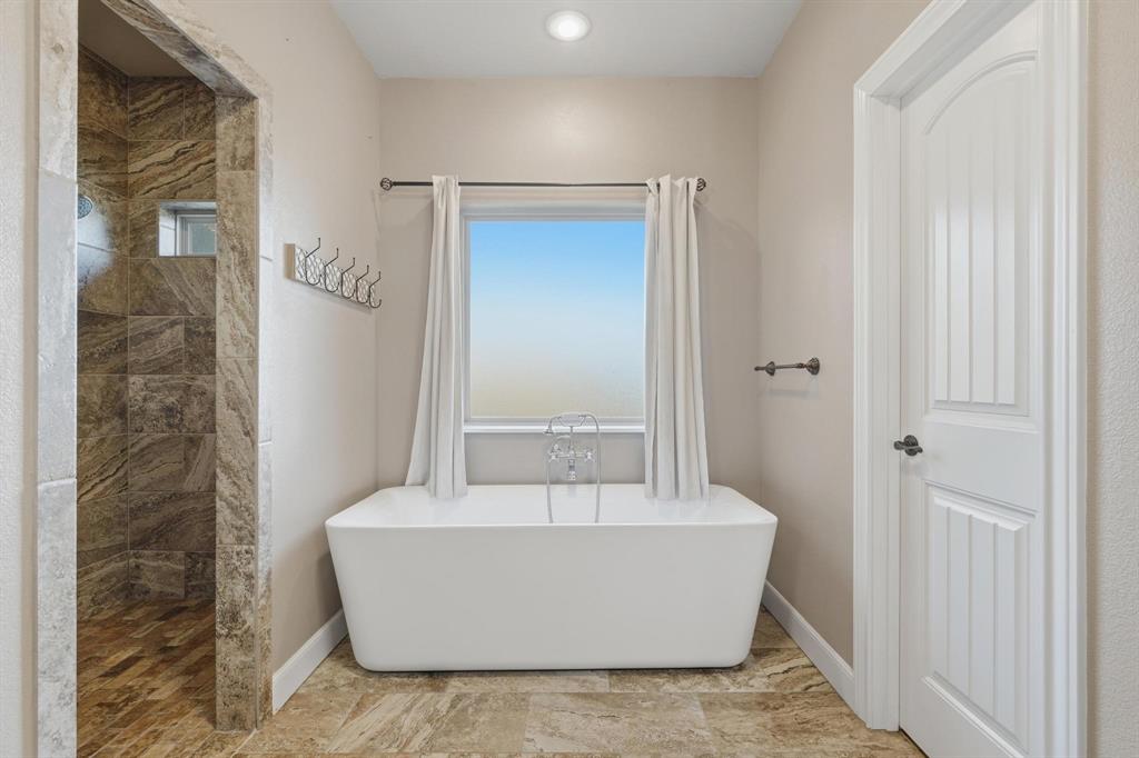 109 Benton Tuscola, TX 79562 - Photo 14 of 40 a white bath tub sitting in a bathroom