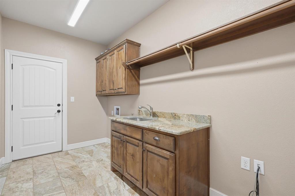 109 Benton Tuscola, TX 79562 - Photo 17 of 40 a utility room with cabinets