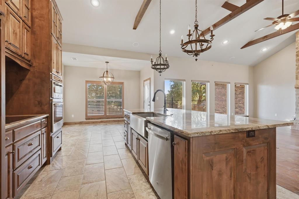 109 Benton Tuscola, TX 79562 - Photo 6 of 40 a kitchen with a counter space a sink appliances and cabinets