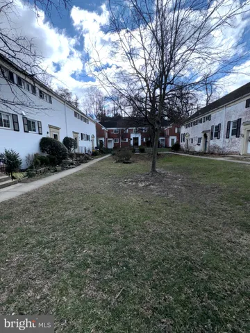 a yellow house sitting in middle of a field