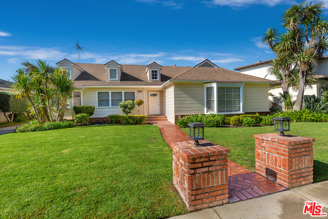 a view of a house with a yard porch and sitting area