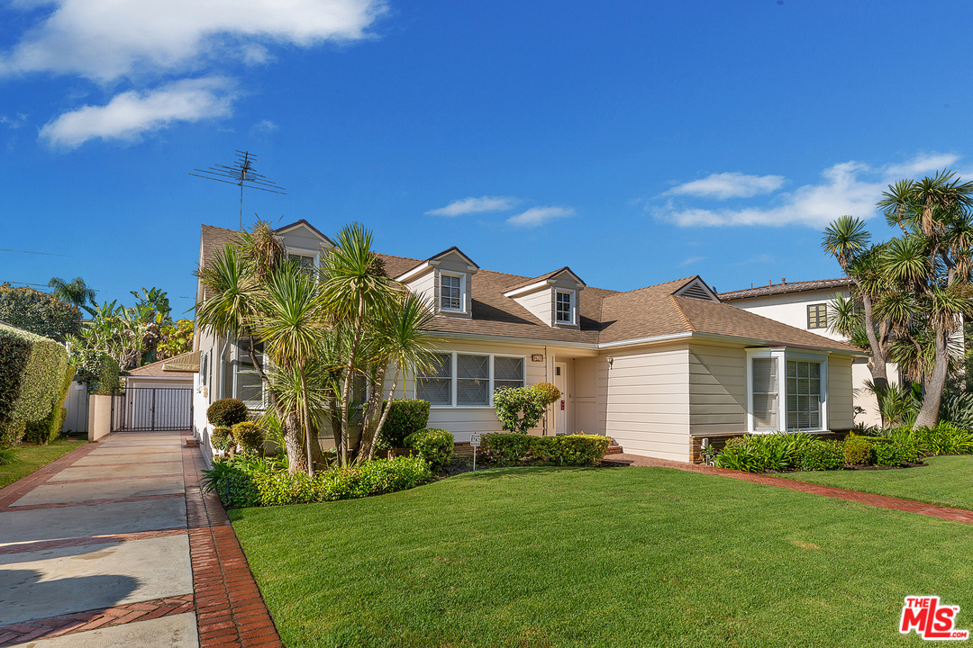 9428 Duxbury Road Los Angeles, CA 90034 - Photo 2 of 17 a front view of a house with a garden