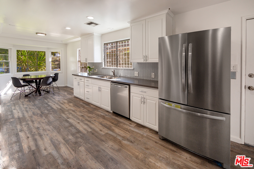 9428 Duxbury Road Los Angeles, CA 90034 - Photo 5 of 17 a kitchen with a refrigerator a sink and a stove top oven