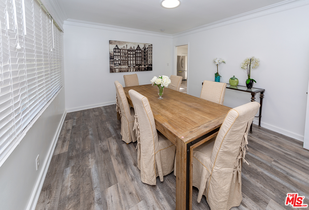 9428 Duxbury Road Los Angeles, CA 90034 - Photo 7 of 17 a view of a dining room with furniture and wooden floor