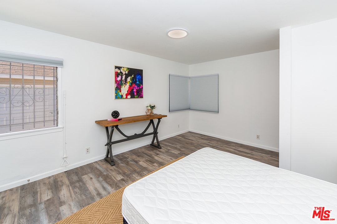 9428 Duxbury Road Los Angeles, CA 90034 - Photo 9 of 17 a bedroom with a bed and a window