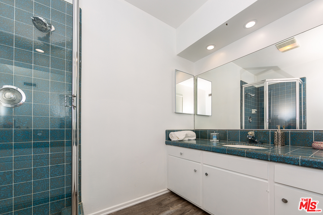 9428 Duxbury Road Los Angeles, CA 90034 - Photo 10 of 17 a bathroom with a granite countertop sink and a mirror