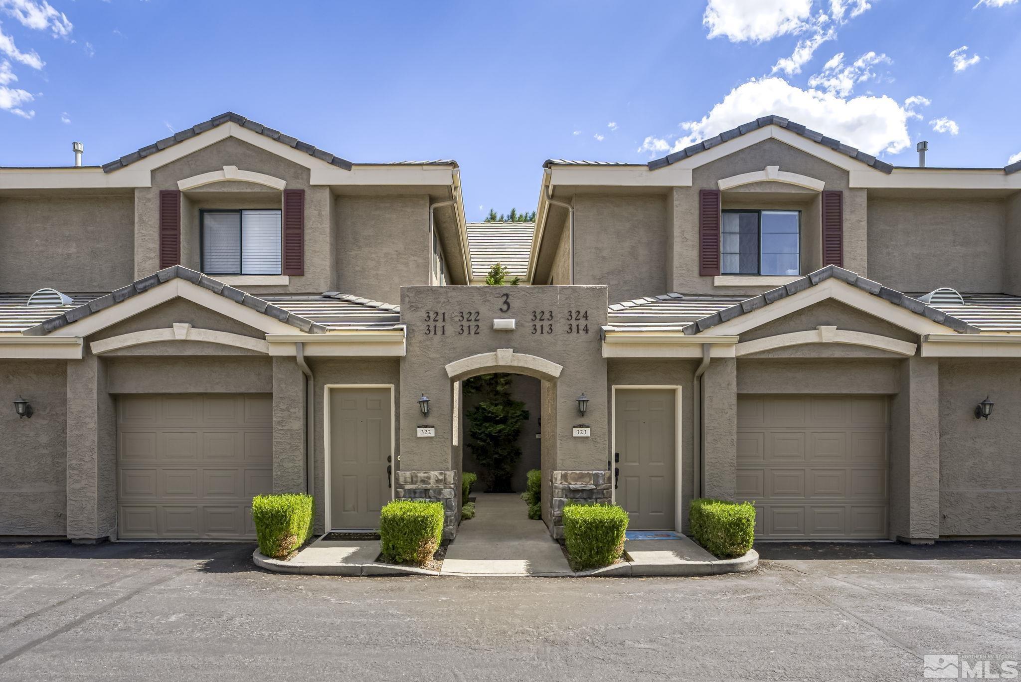 900 South Meadows Parkway, Unit 312 Reno, NV 89521 - Photo 1 of 38 a front view of a house with yard and parking