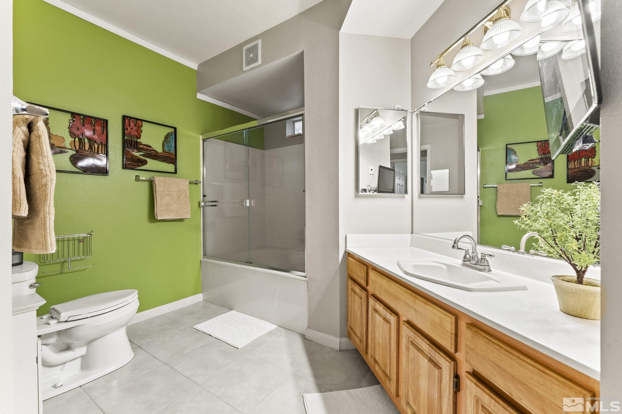 900 South Meadows Parkway, Unit 312 Reno, NV 89521 - Photo 13 of 38 a bathroom with a granite countertop sink a toilet a mirror and shower