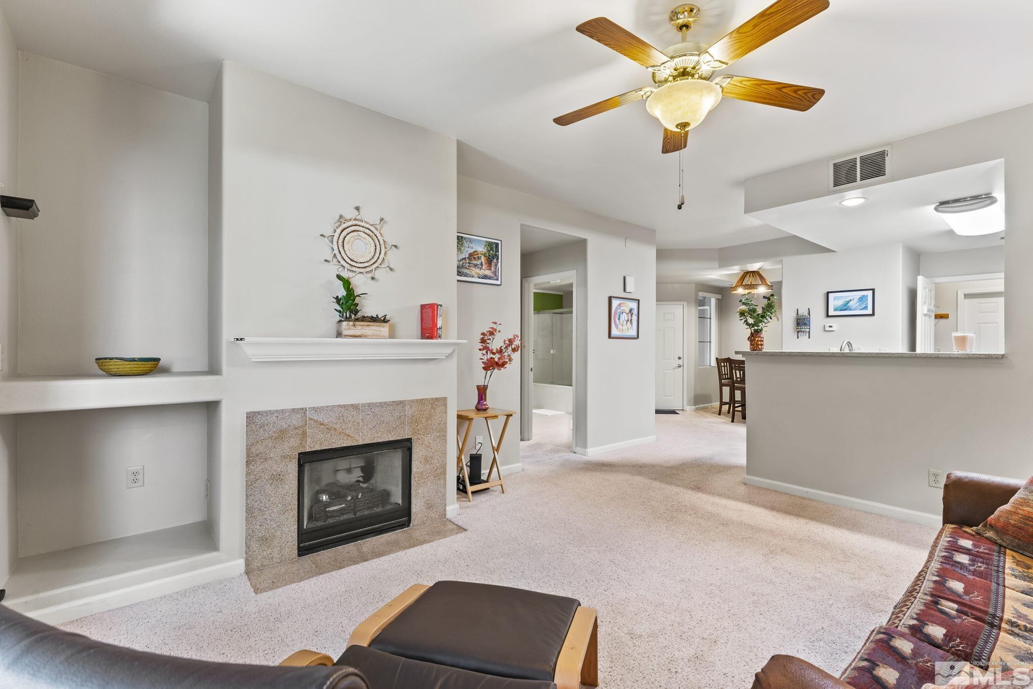 900 South Meadows Parkway, Unit 312 Reno, NV 89521 - Photo 16 of 38 a living room with furniture and a fireplace