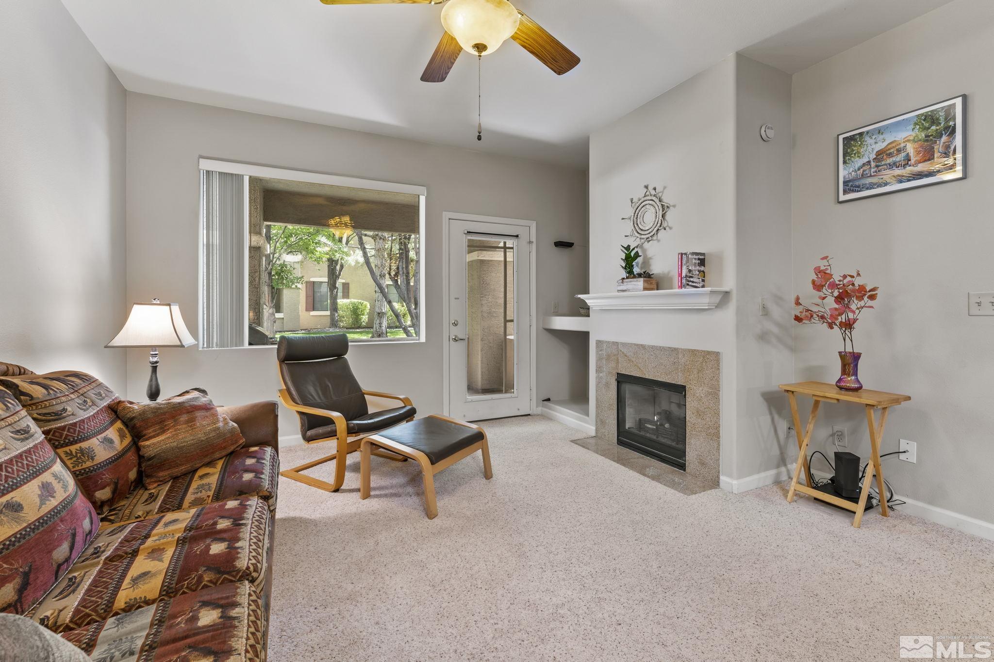 900 South Meadows Parkway, Unit 312 Reno, NV 89521 - Photo 17 of 38 a living room with furniture and a fireplace