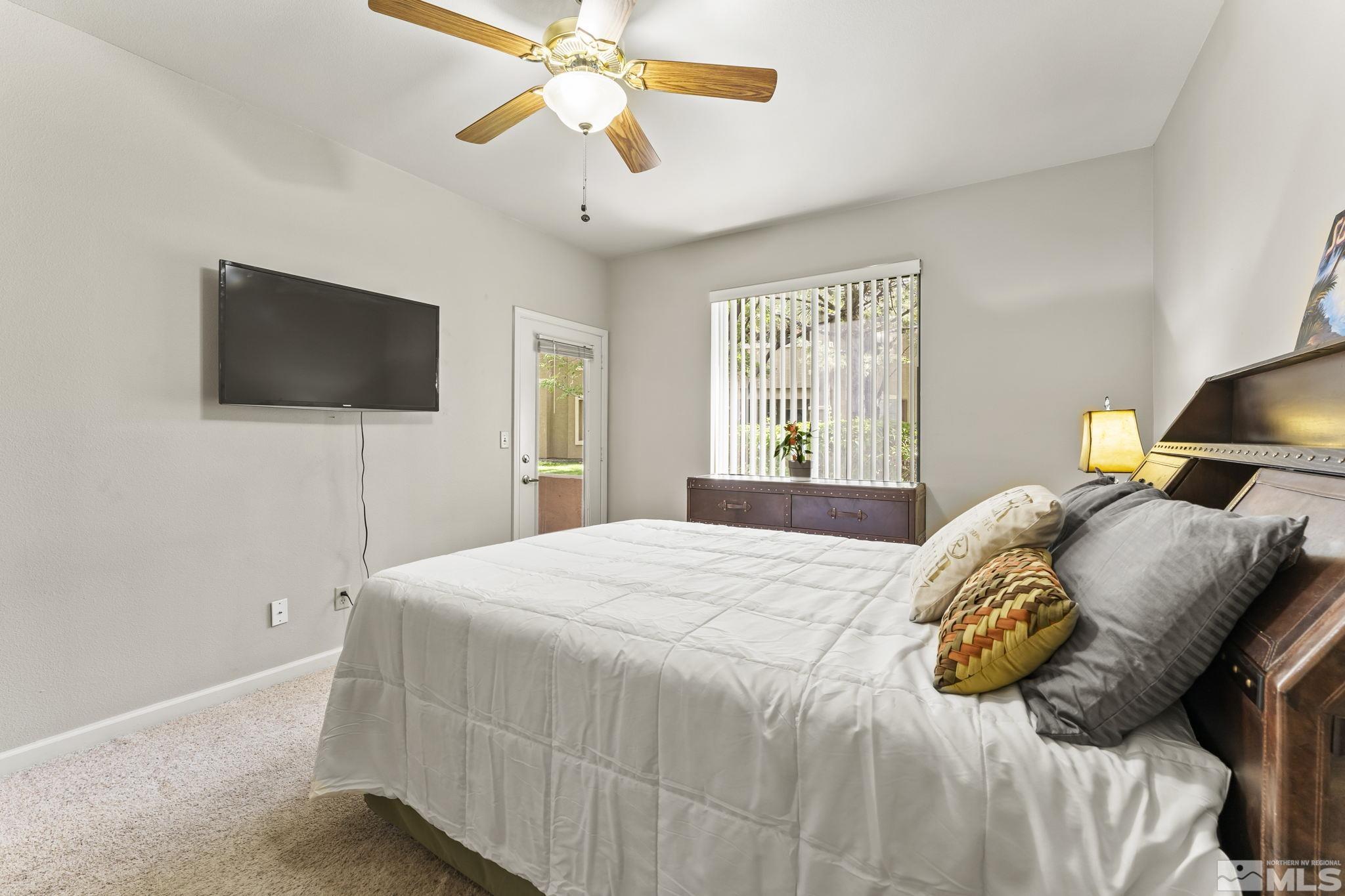 900 South Meadows Parkway, Unit 312 Reno, NV 89521 - Photo 20 of 38 a bedroom with a bed and a flat screen tv