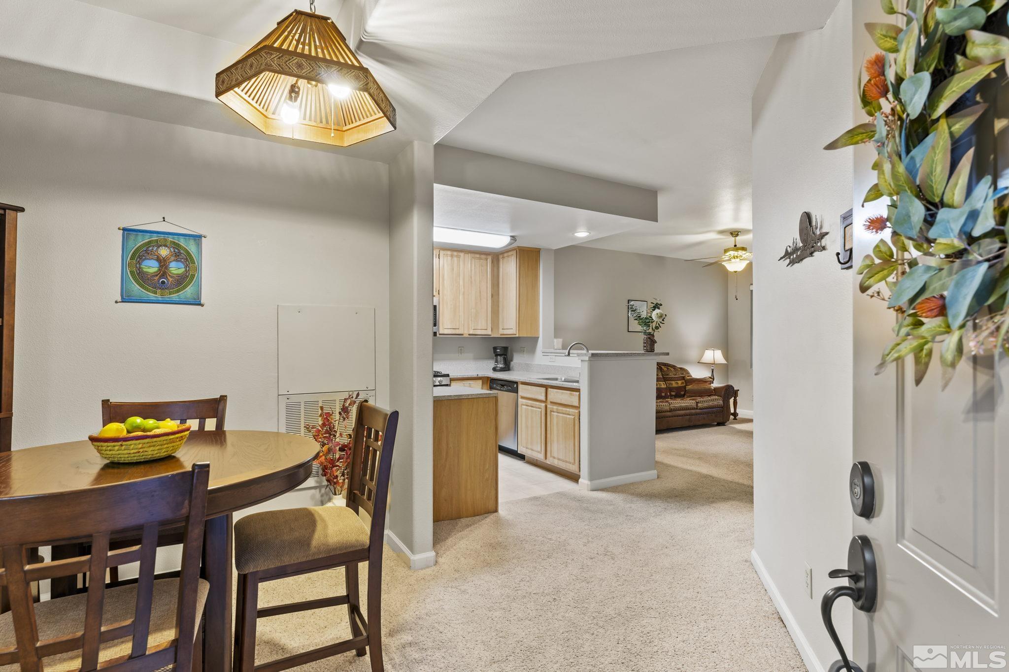 900 South Meadows Parkway, Unit 312 Reno, NV 89521 - Photo 5 of 38 a view of a dining room with furniture and a chandelier