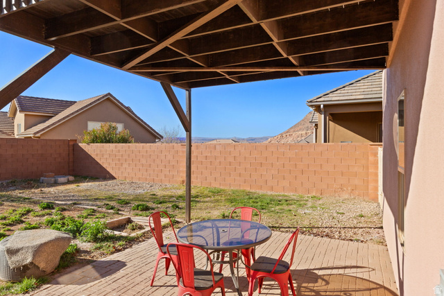 1570 South Rio Virgin Drive Washington, UT 84780 - Photo 67 of 71 Fenced backyard with outdoor dining area and a wooden deck