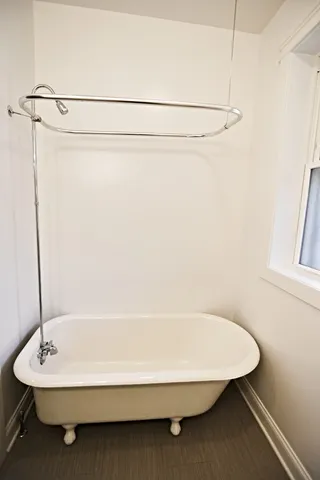 a bathroom with a bathtub and a shower
