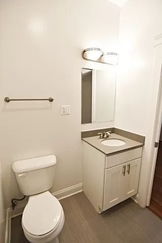 a bathroom with a sink a toilet and mirror