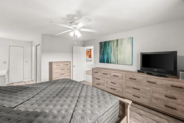 a bedroom with a bed and a flat screen tv in it