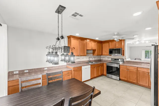 a kitchen with stainless steel appliances granite countertop a stove and kitchen island