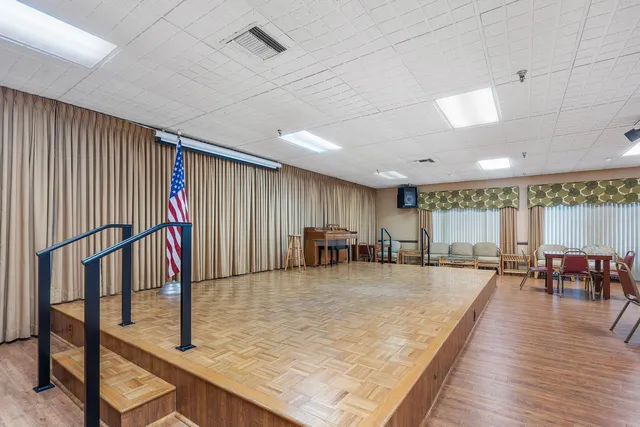 a large hall with lots of dining table and chairs