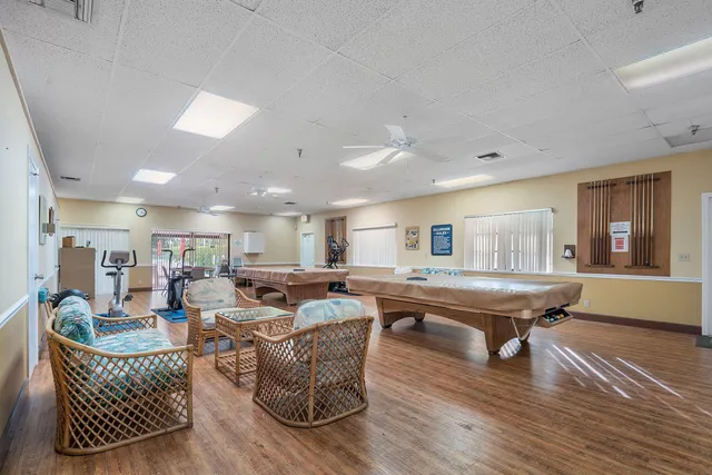 a living room with furniture a wooden floor and a window