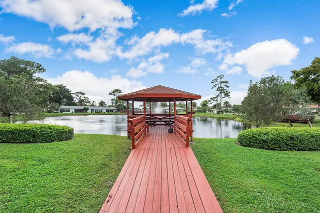 a lake view with a big yard and potted plants