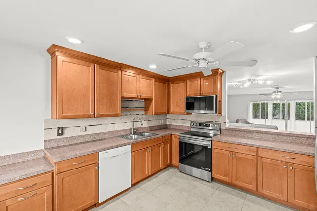 a kitchen with stainless steel appliances granite countertop a sink and cabinets
