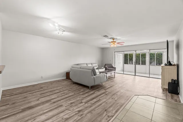 a living room with furniture and large window