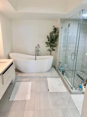 a bathroom with a bathtub and shower
