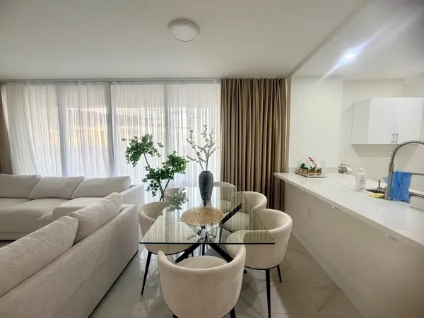 a living room with furniture and a large window