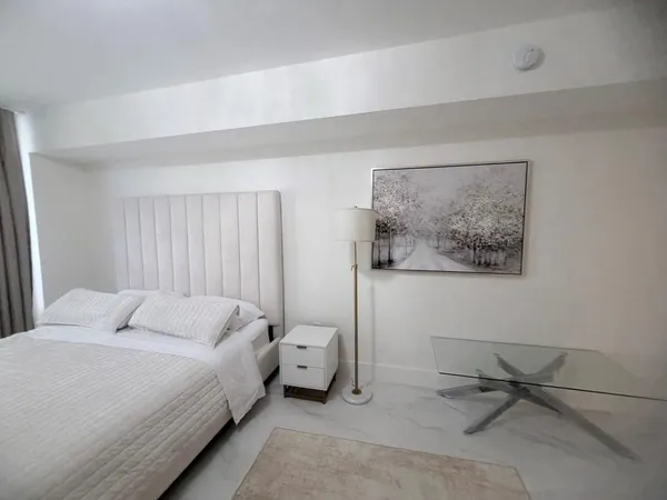 a bedroom with a bed and glass wall