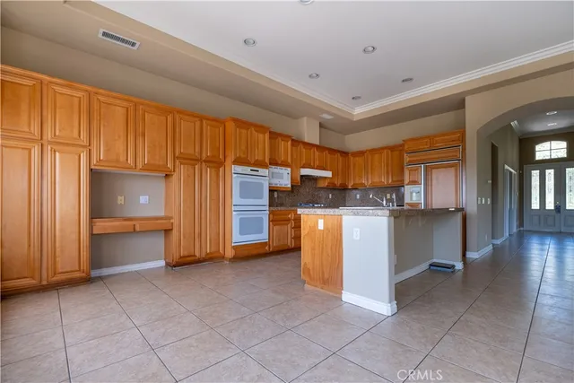 a kitchen with stainless steel appliances granite countertop a refrigerator and a stove