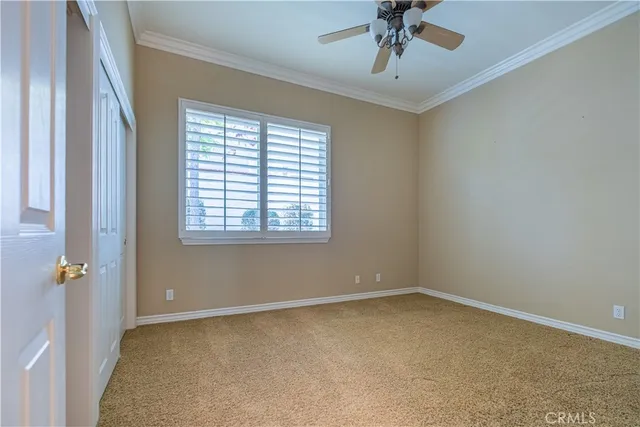 a view of a livingroom with a ceiling fan and window