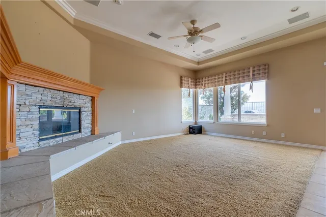 a view of an empty room with a fireplace and a window