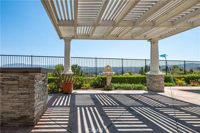 a view of a patio with table and chairs and potted plants