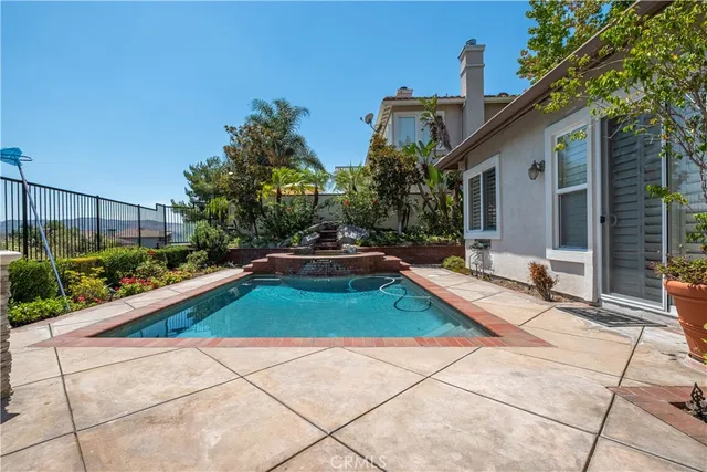 a view of a patio with iron fence