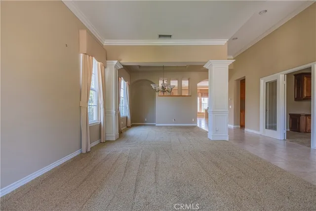 a view of a hallway with wooden floor and a living room