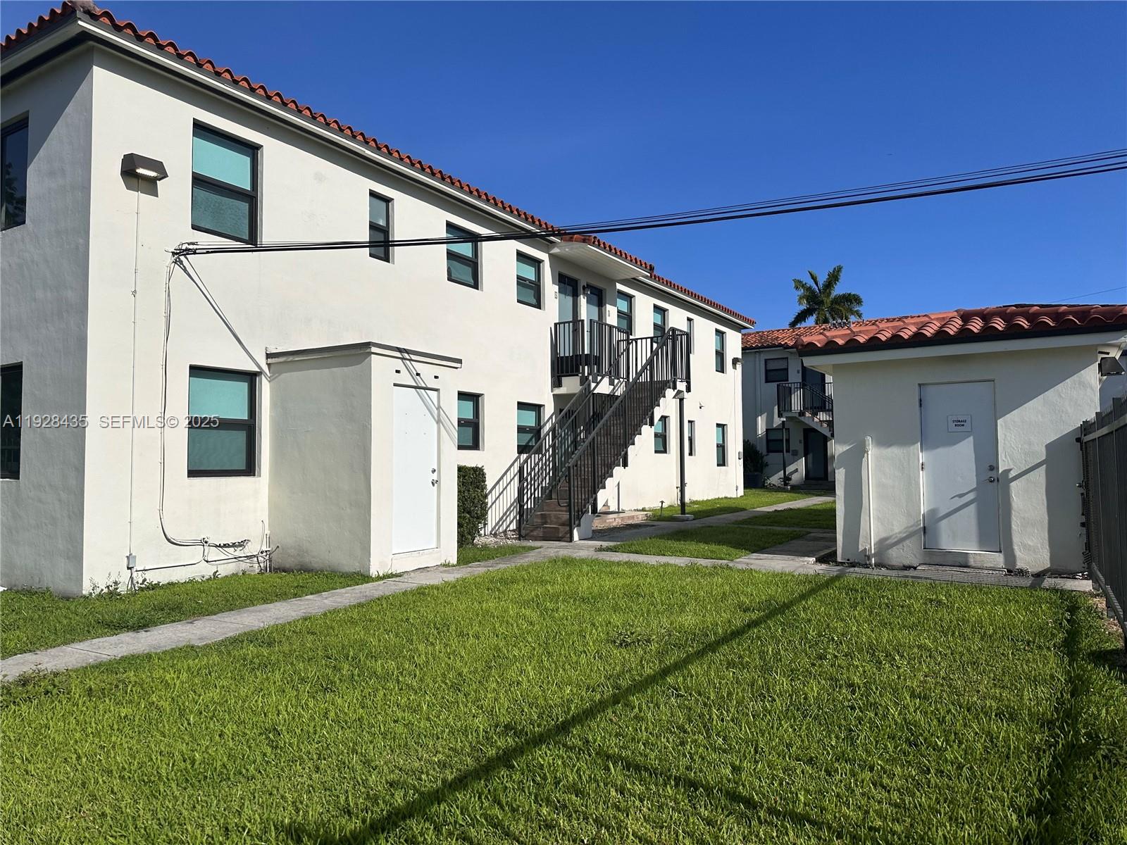 4204 Southwest 14th Street, Unit 3 Miami, FL 33134 - Photo 1 of 12 a view of a white house with a big yard and large windows