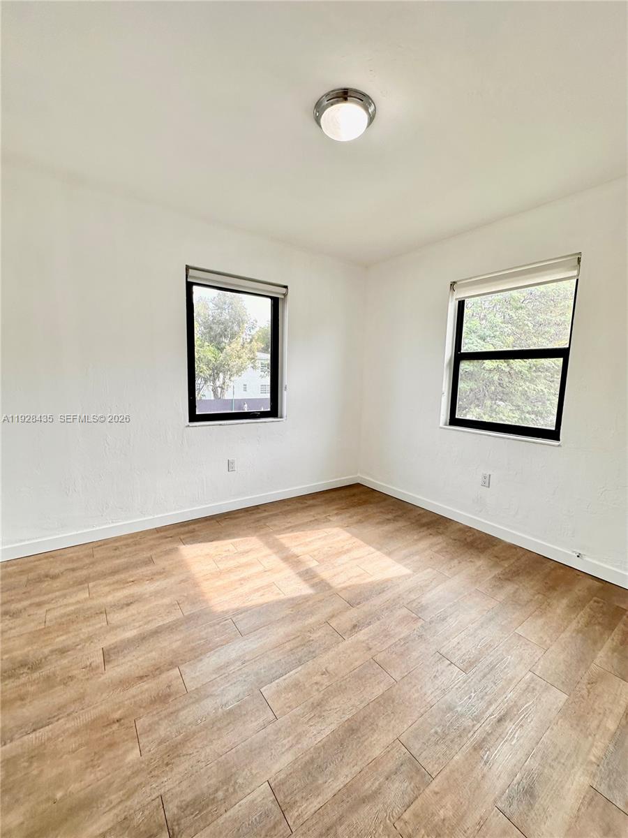 4204 Southwest 14th Street, Unit 3 Miami, FL 33134 - Photo 15 of 15 a view of an empty room with window and wooden floor