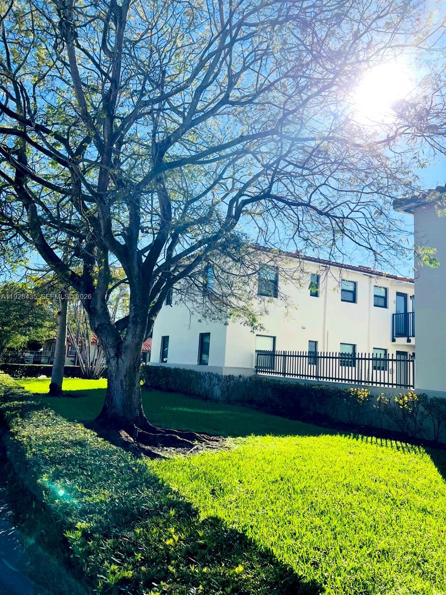 4204 Southwest 14th Street, Unit 3 Miami, FL 33134 - Photo 4 of 15 a view of a house with a big yard and large trees