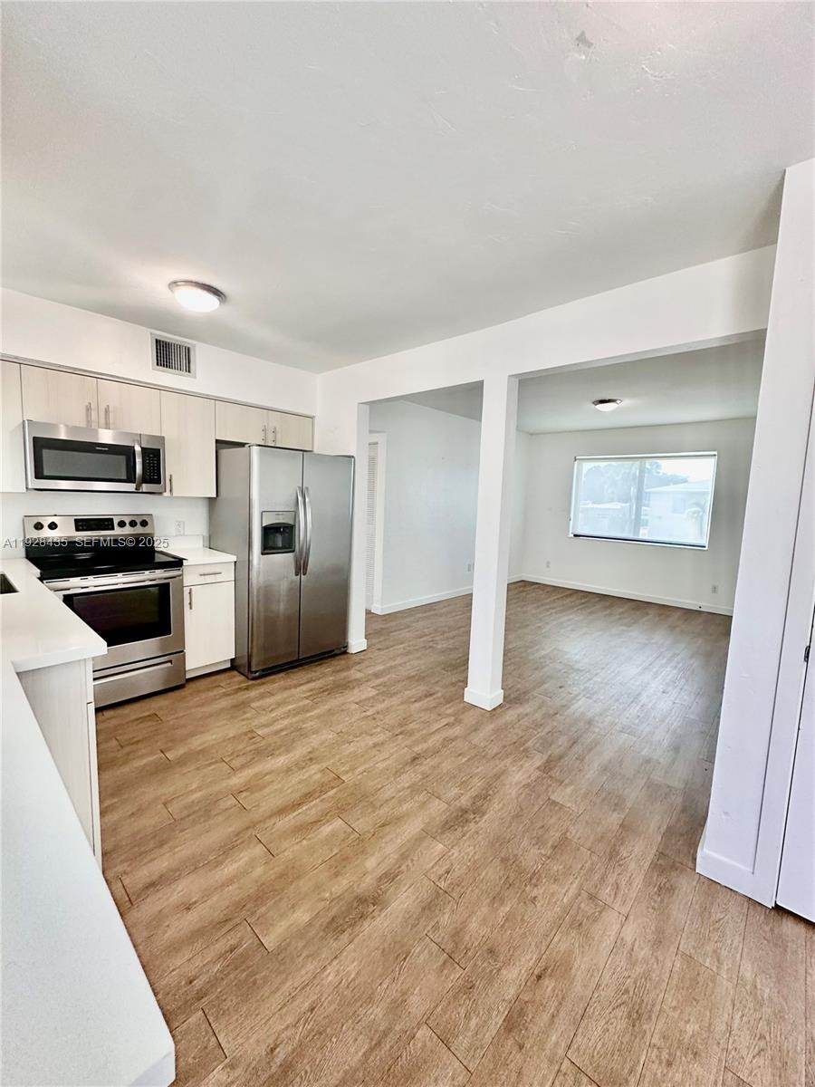 4204 Southwest 14th Street, Unit 3 Miami, FL 33134 - Photo 4 of 12 a view of a kitchen with a sink and a refrigerator