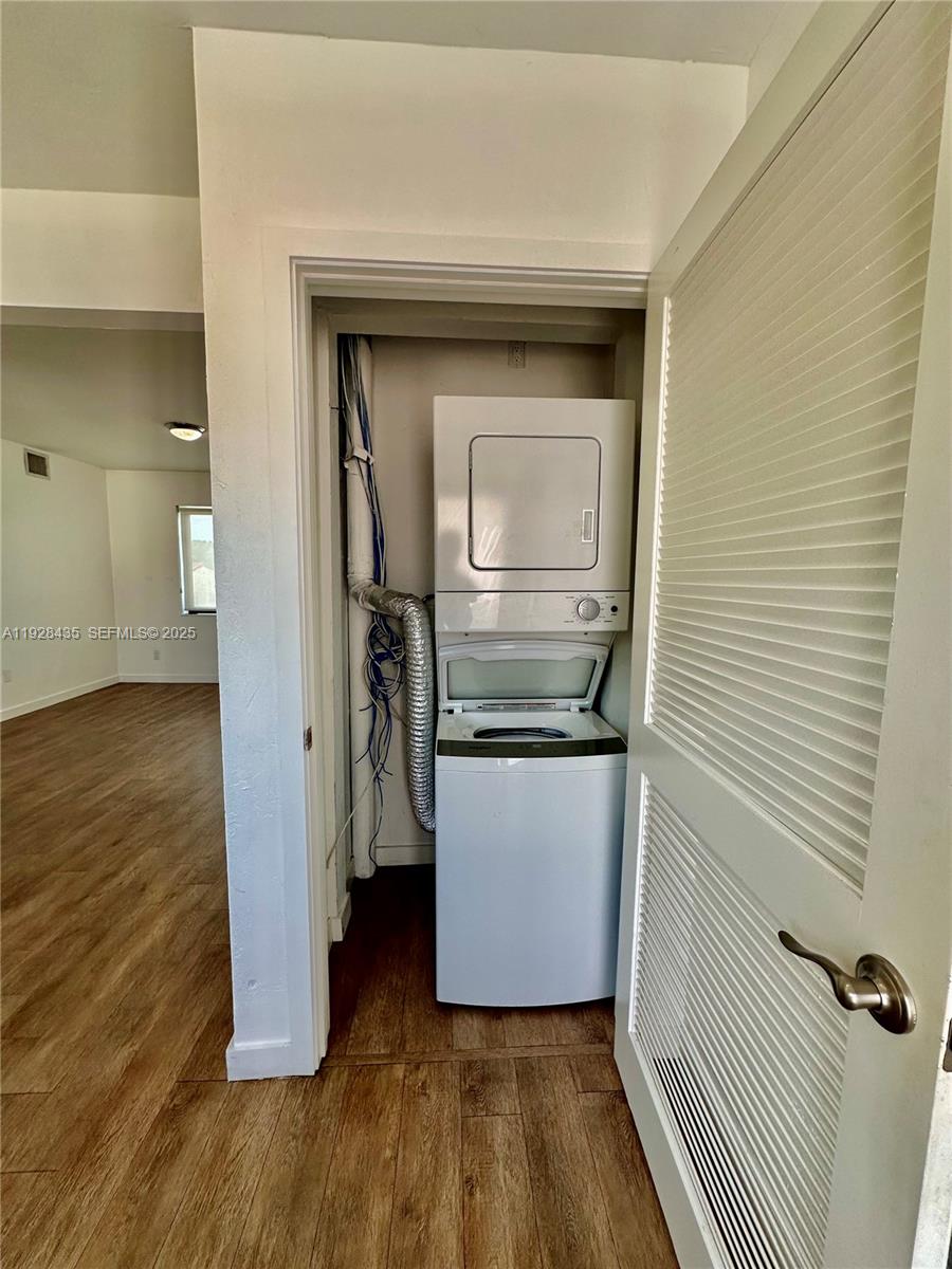 4204 Southwest 14th Street, Unit 3 Miami, FL 33134 - Photo 8 of 12 a kitchen with a refrigerator and wooden floor