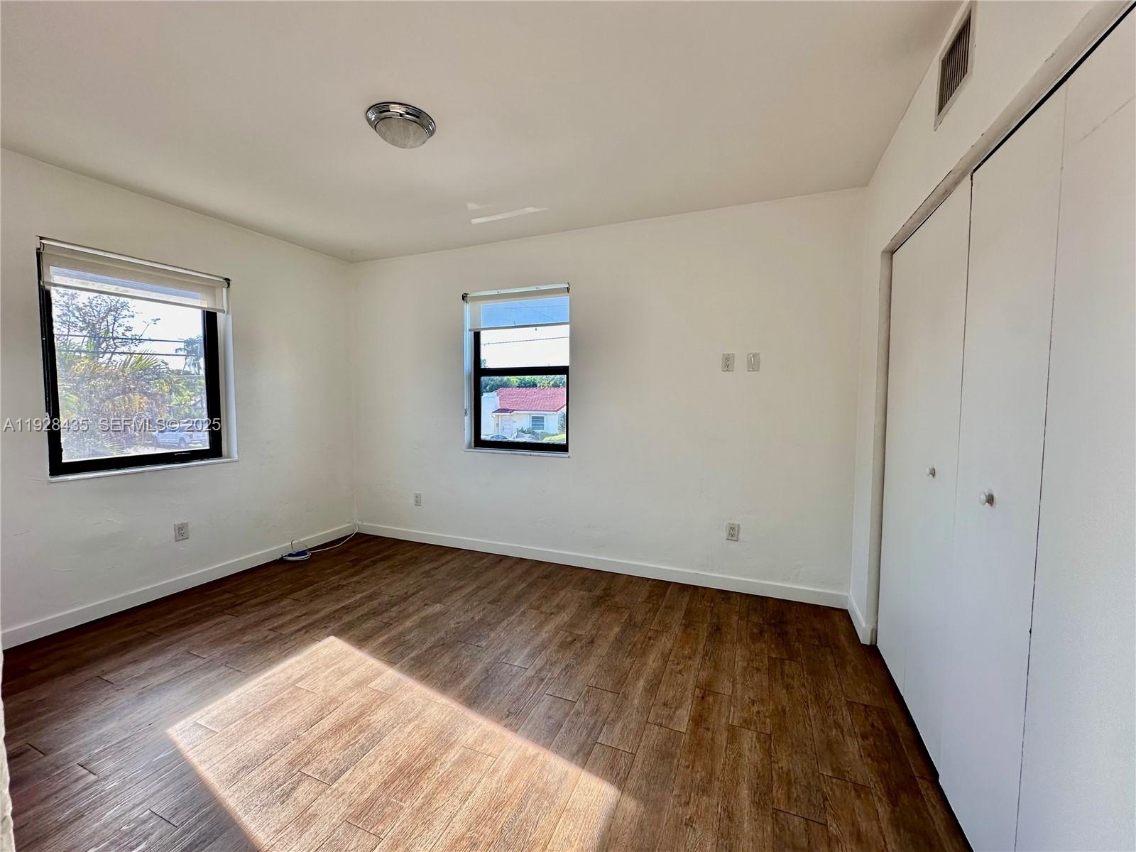 4204 Southwest 14th Street, Unit 3 Miami, FL 33134 - Photo 9 of 12 an empty room with wooden floor and windows