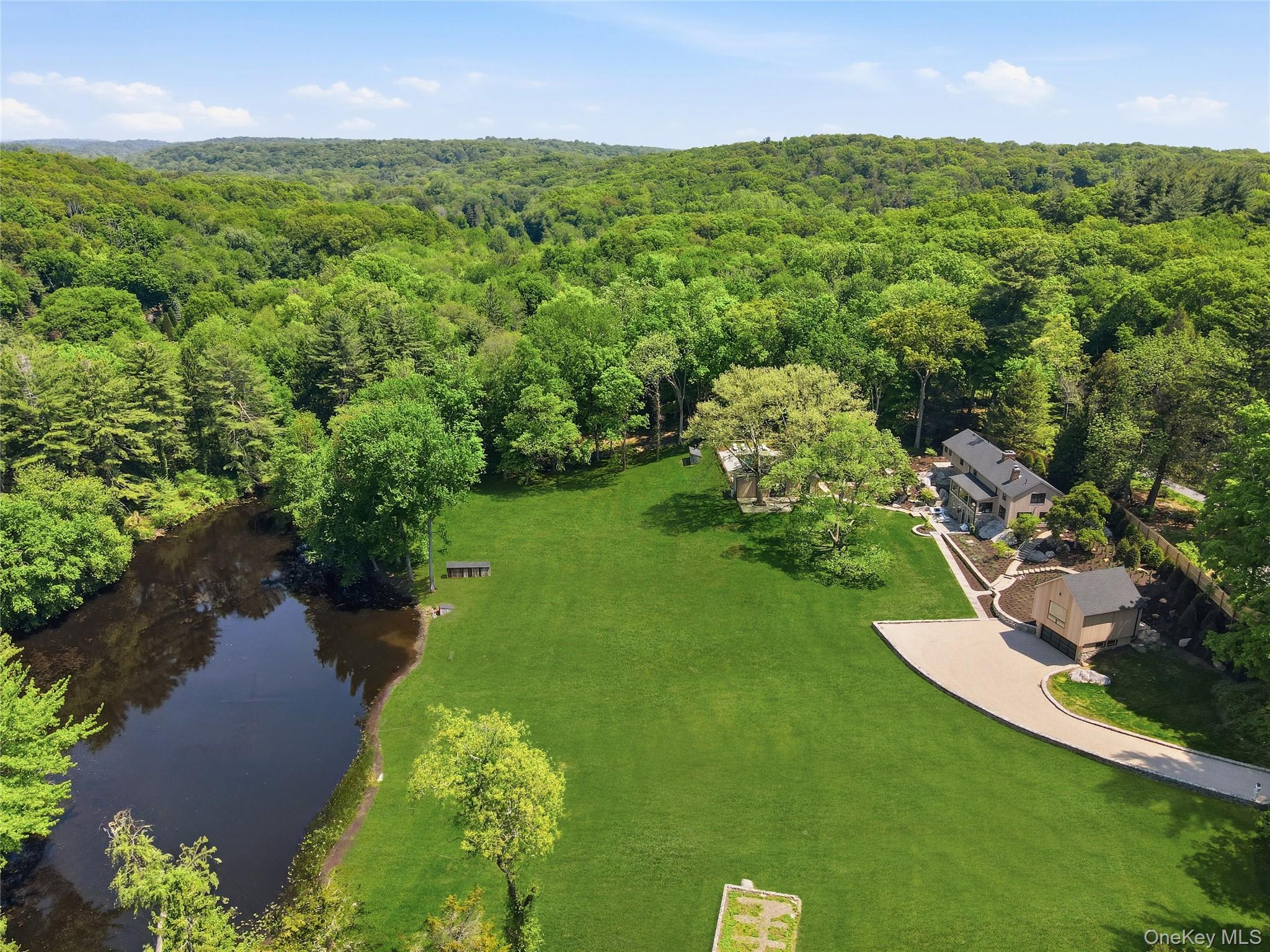 39 Old Snake Hill Road Pound Ridge, NY 10576 - Photo 30 of 37 an aerial view of a houses with a yard