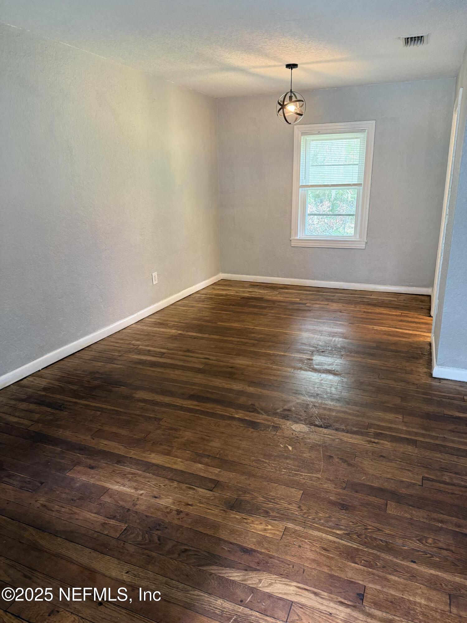 1925 Jones Street Jacksonville, FL 32206 - Photo 2 of 6 an empty room with wooden floor and windows