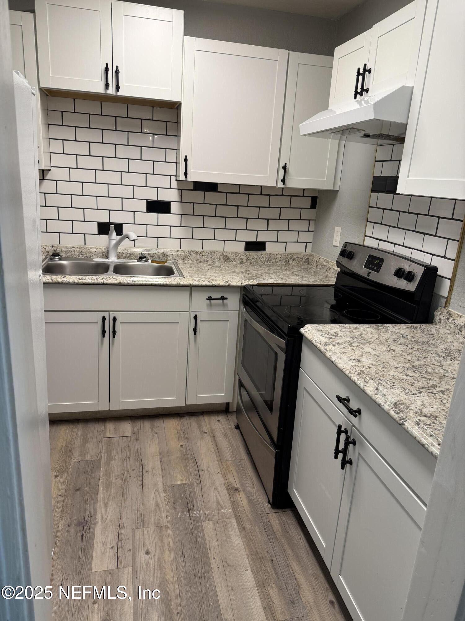 1925 Jones Street Jacksonville, FL 32206 - Photo 3 of 6 a kitchen with a sink stove and cabinets