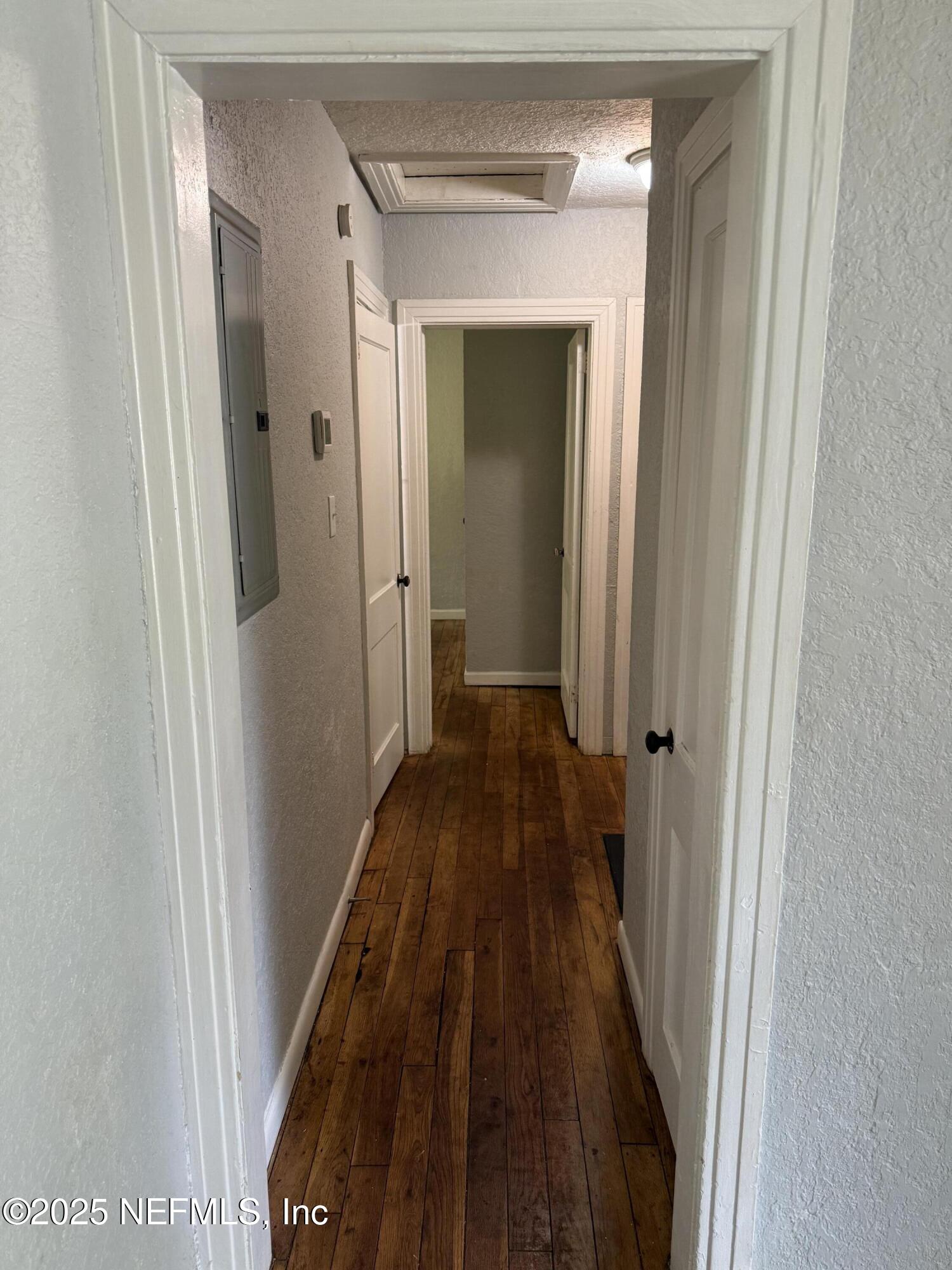 1925 Jones Street Jacksonville, FL 32206 - Photo 4 of 6 a view of a hallway with wooden floor and a bathroom